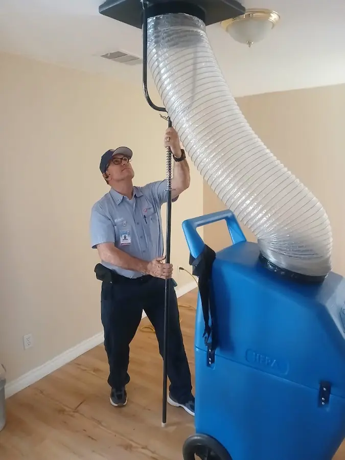 Furnace Tune-Up technician using HEPA equipment in Alpine